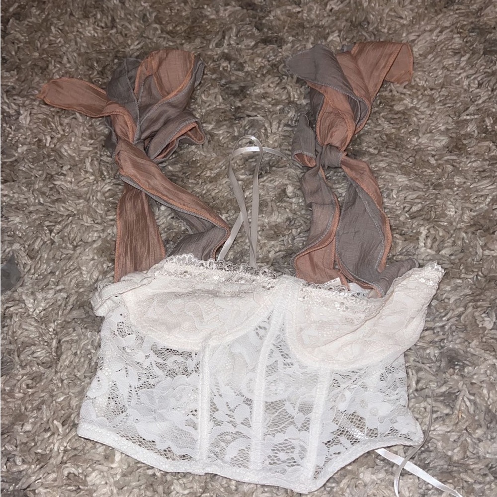 Cropped white corset too with tie sleeves.